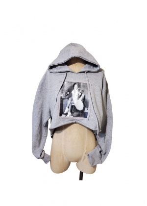 A mannequin wearing a gray hoodie with a picture of a woman.