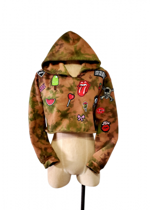A mannequin wearing a camouflage jacket with stickers on it.